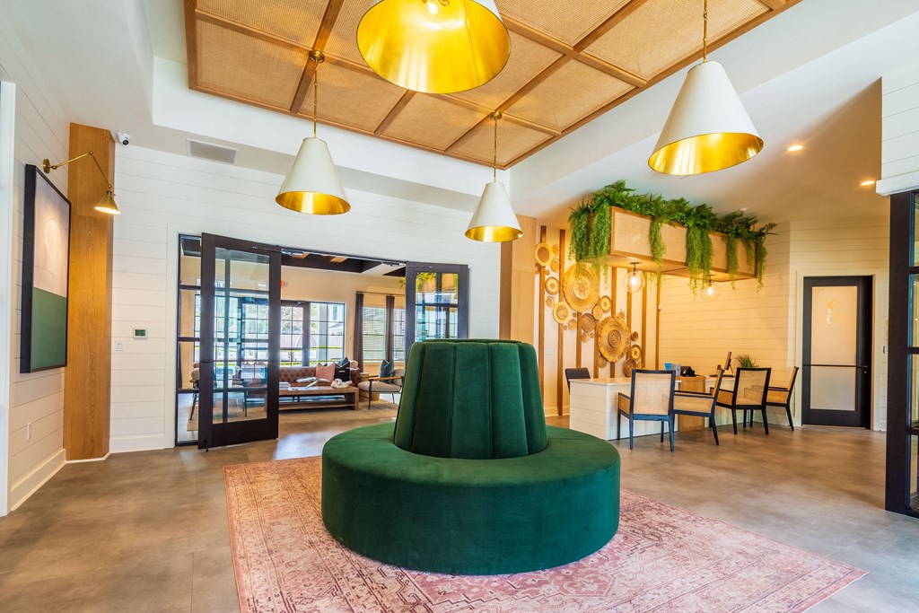 a living room with a green couch and a table with chairs