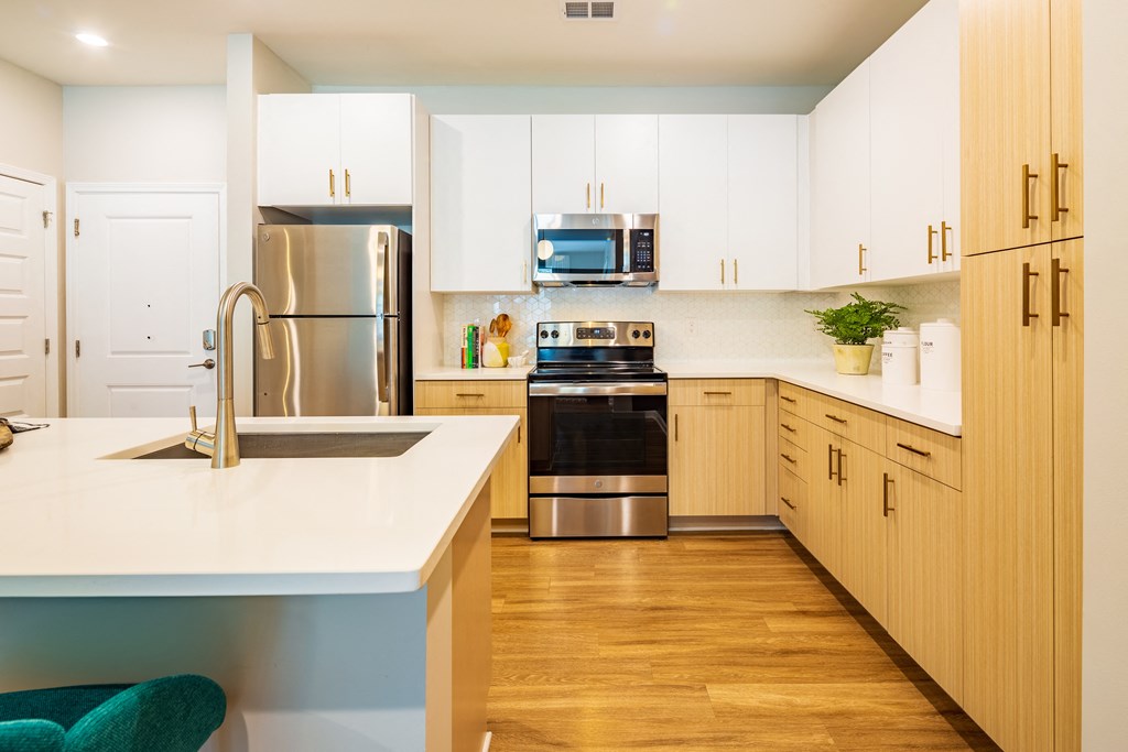 a modern kitchen with white cabinets and stainless steel appliances