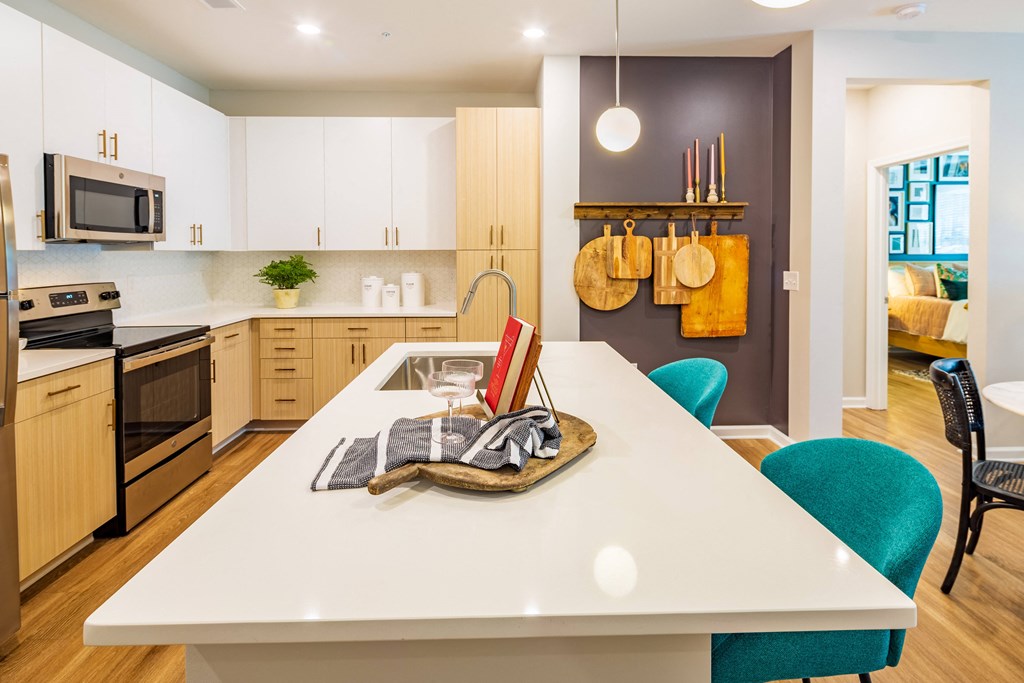 an open kitchen and dining room with a white table