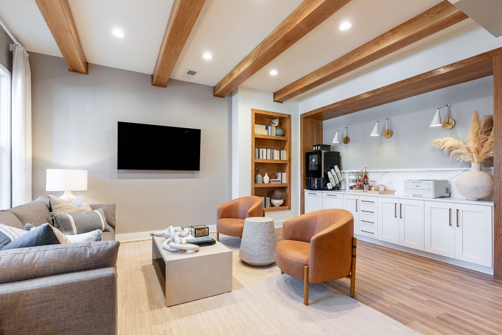 a living room with couches and chairs and a tv