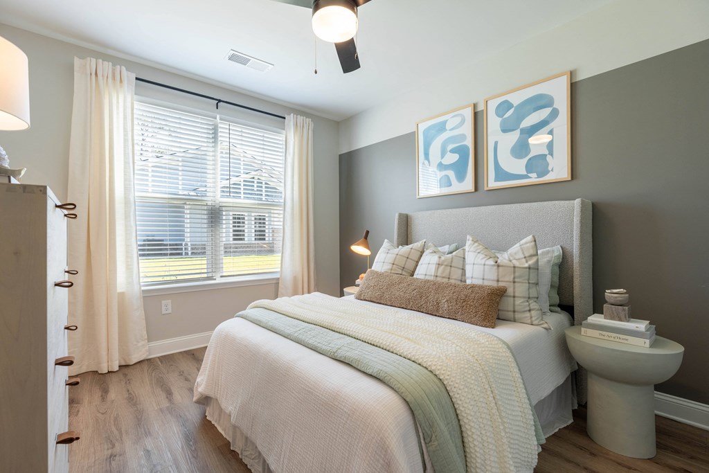 a bedroom with a bed and a toilet and a window