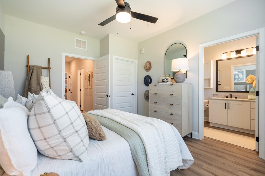 a bedroom with a bed and a ceiling fan