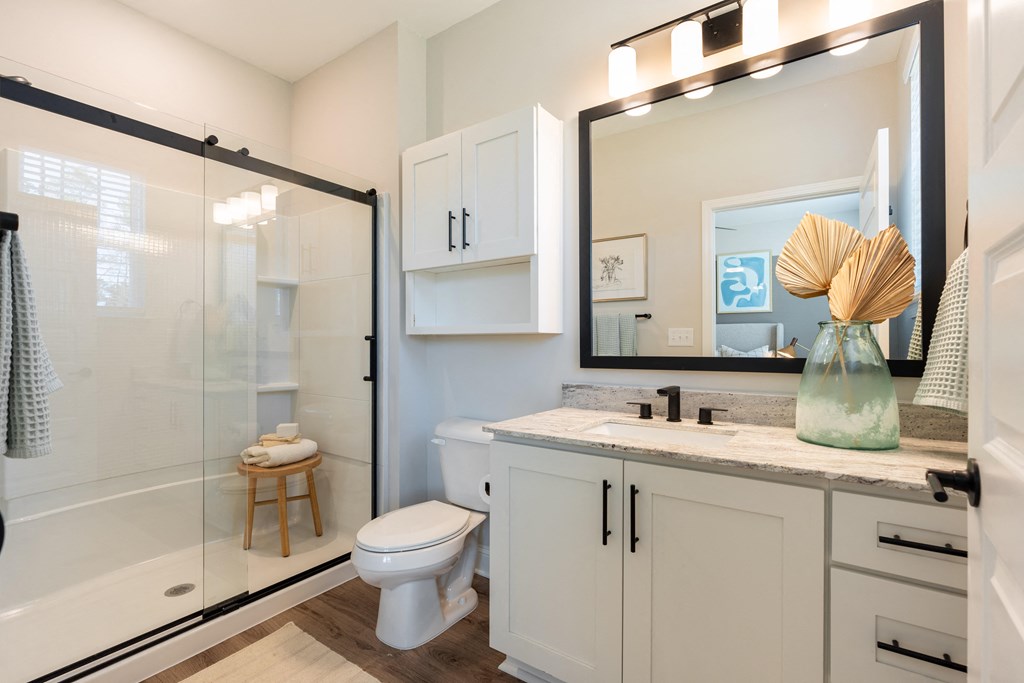 a bathroom with a shower and a sink and a toilet