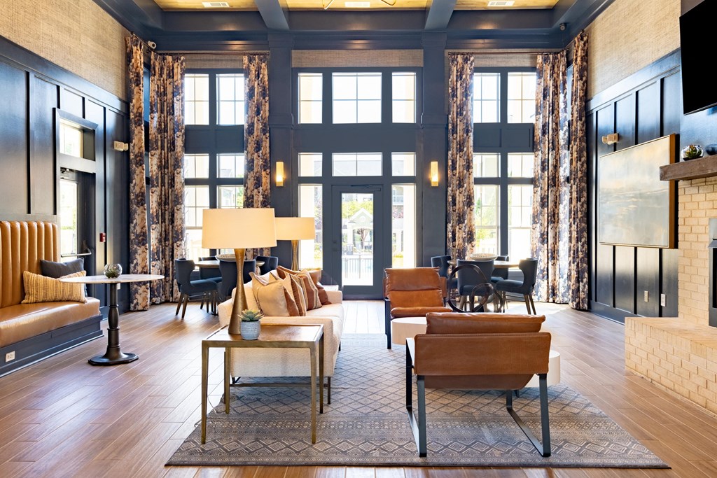 a living room filled with furniture and a large window