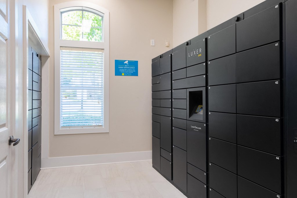 a row of lockers in a room with a window and blinds