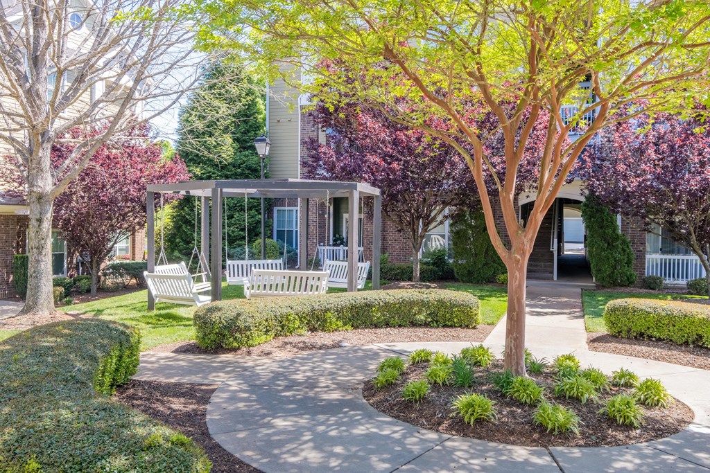 a park with two benches and a gazebo