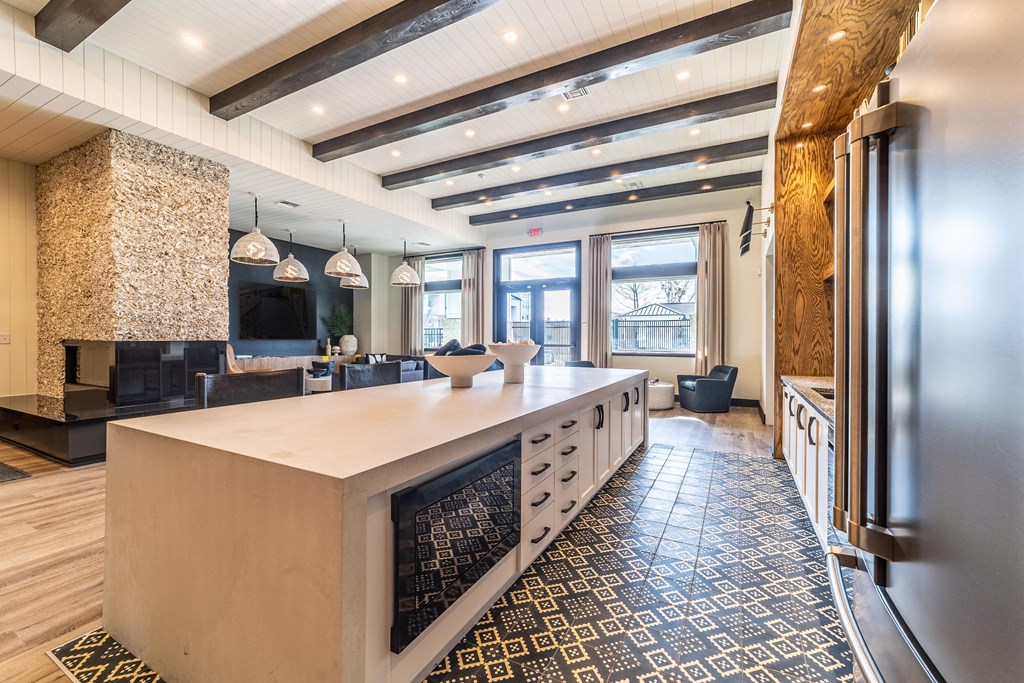 a large kitchen with a large island and a living room