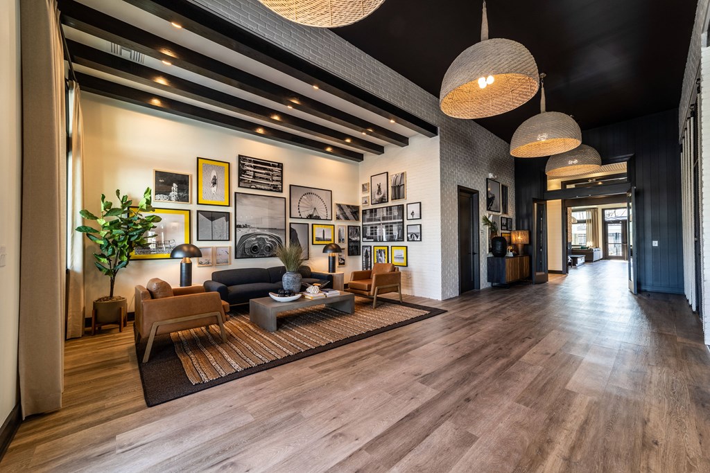 a lobby with couches and chairs and a rug