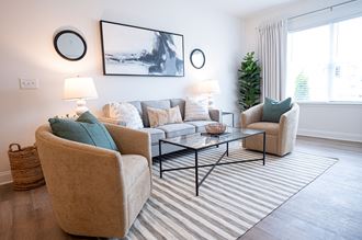 a living room with two couches and two chairs