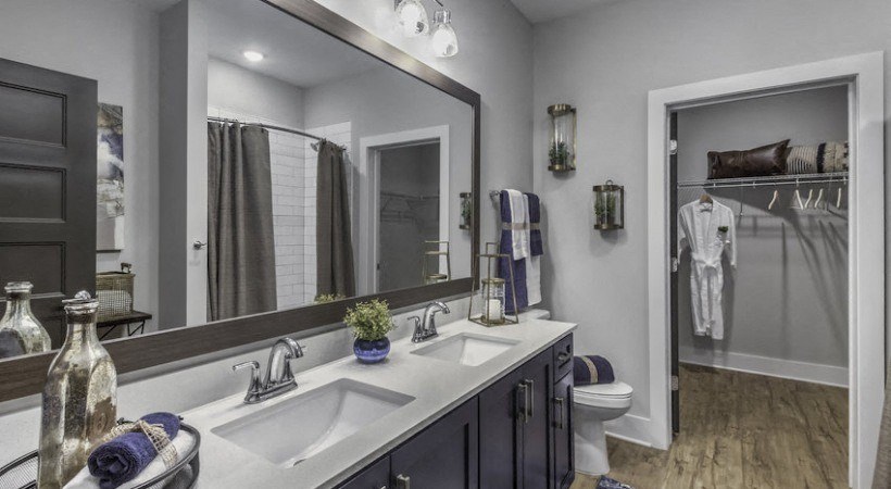 a bathroom with two sinks and a large mirror