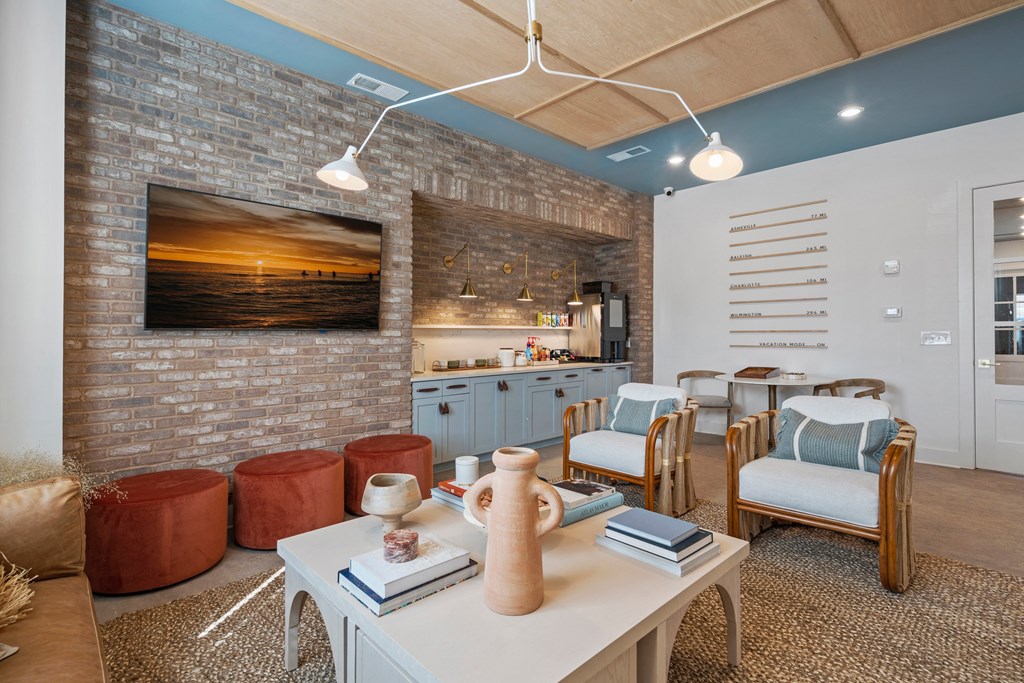 a living room with a dining room table and chairs and a kitchen