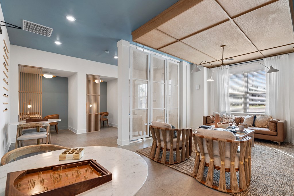 a living room and dining room with a table and chairs