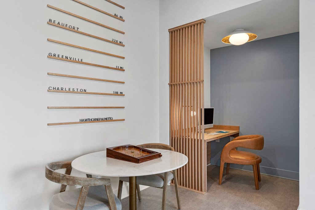 a small table with two chairs and a desk in a room