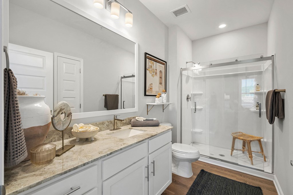 a bathroom with a shower toilet and sink