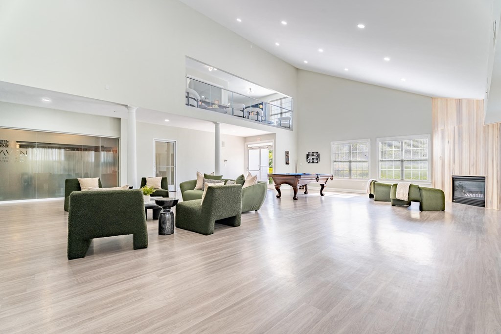 a large living room with furniture and a pool table