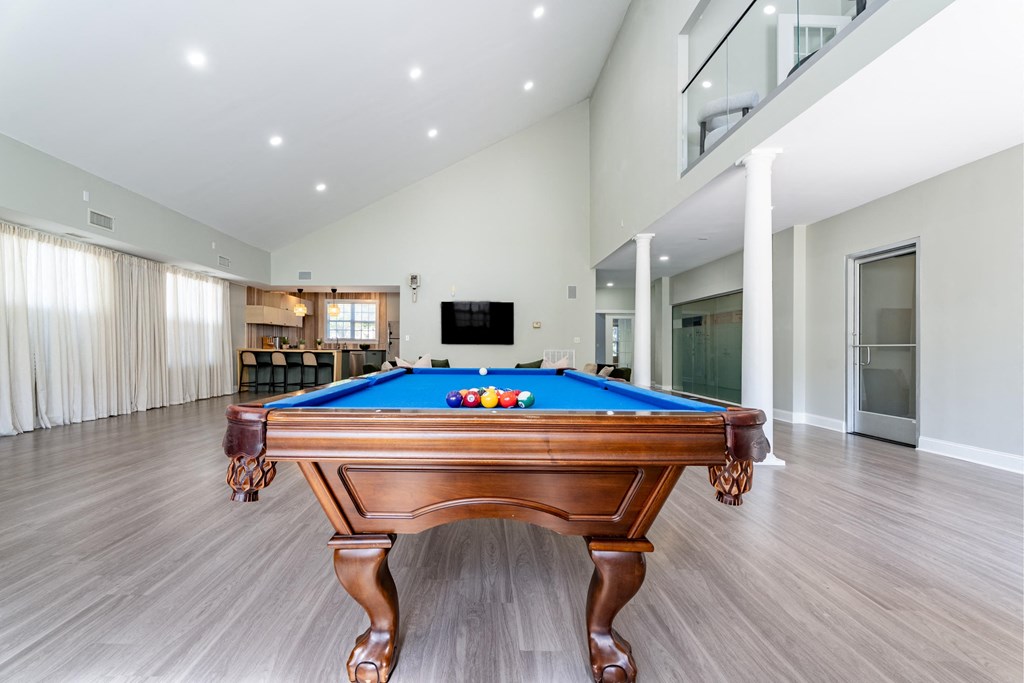 a pool table in the center of a living room