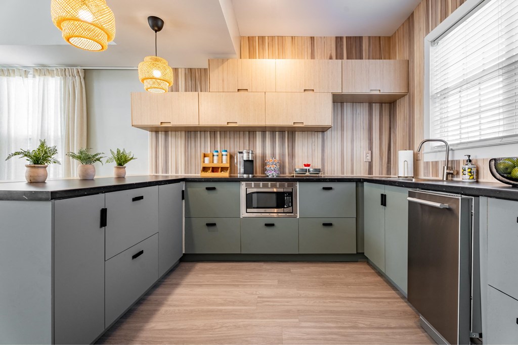 a kitchen with gray cabinets and a wood floor