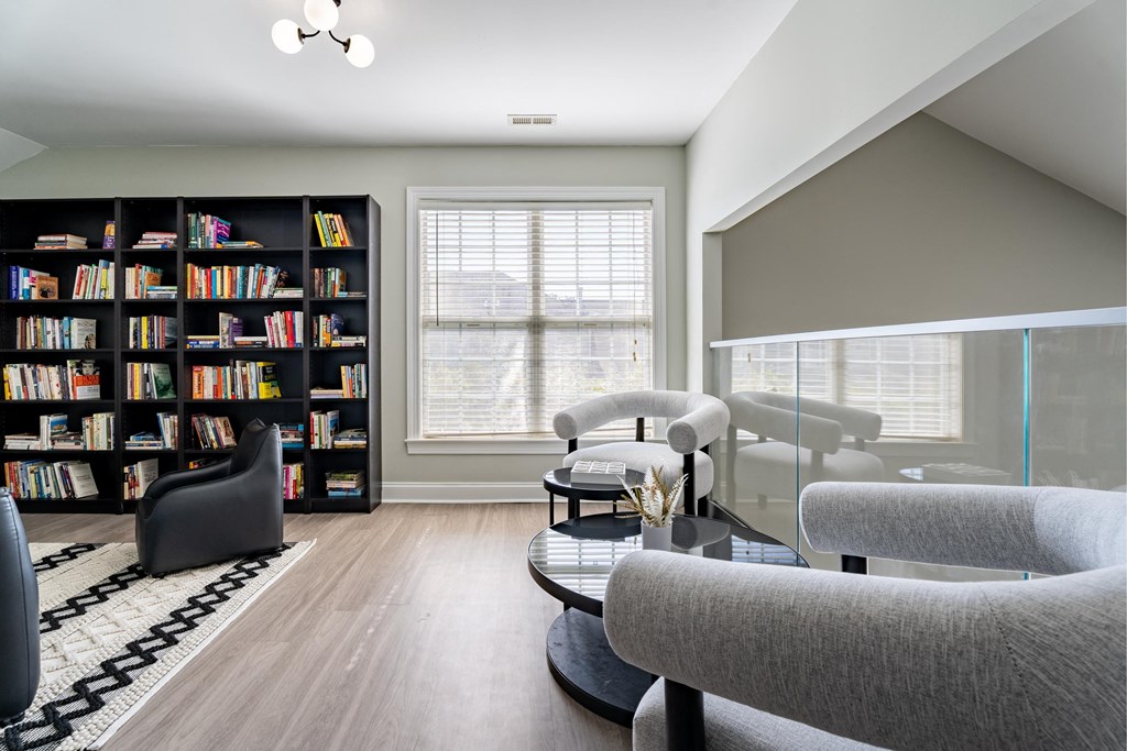 a living room with couches and a coffee table and a book shelf