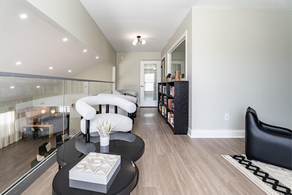 a living room with a white couch and a black coffee table