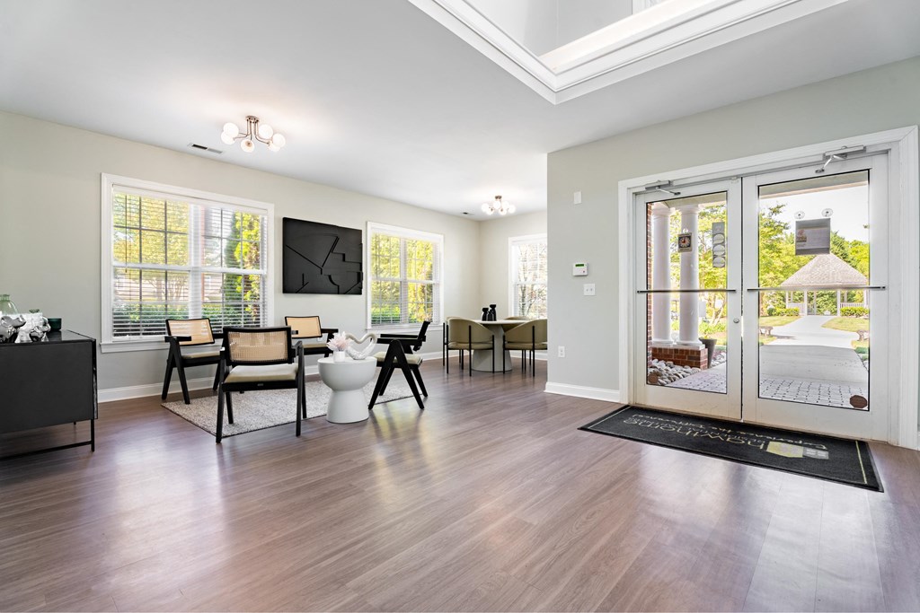 a living room with sliding glass doors and a table with chairs