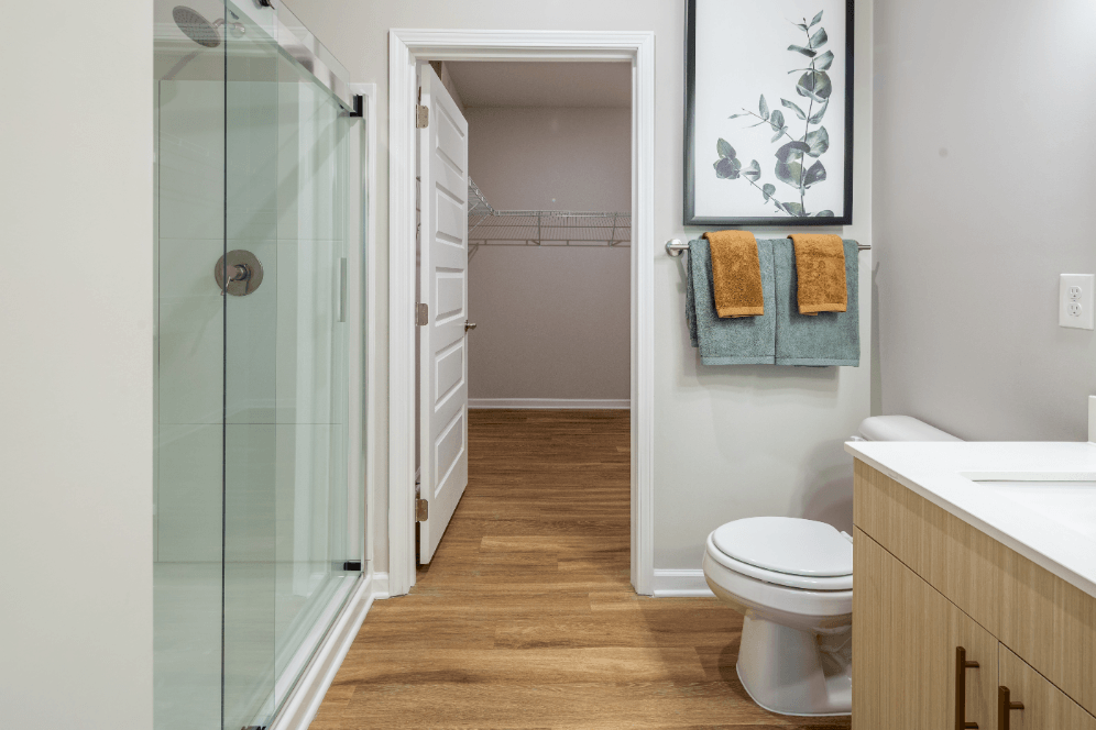 a bathroom with a shower and a toilet and a sink