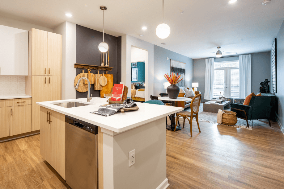 a kitchen with an island and a living room with a dining room