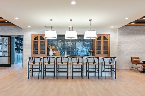 Amenities Apartment clubhouse with a long table and chairs.