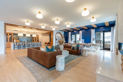 a living room with couches and chairs and a fireplace