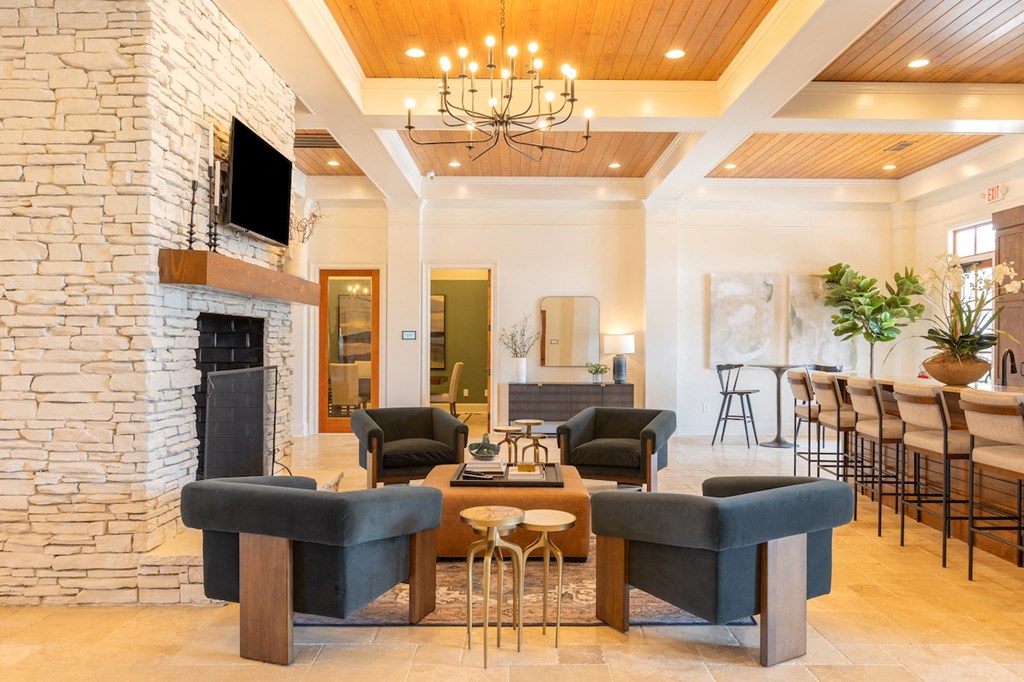 a living room with a fireplace and a table and chairs