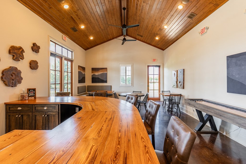 Amenities a large dining room with a long wooden table and chairs