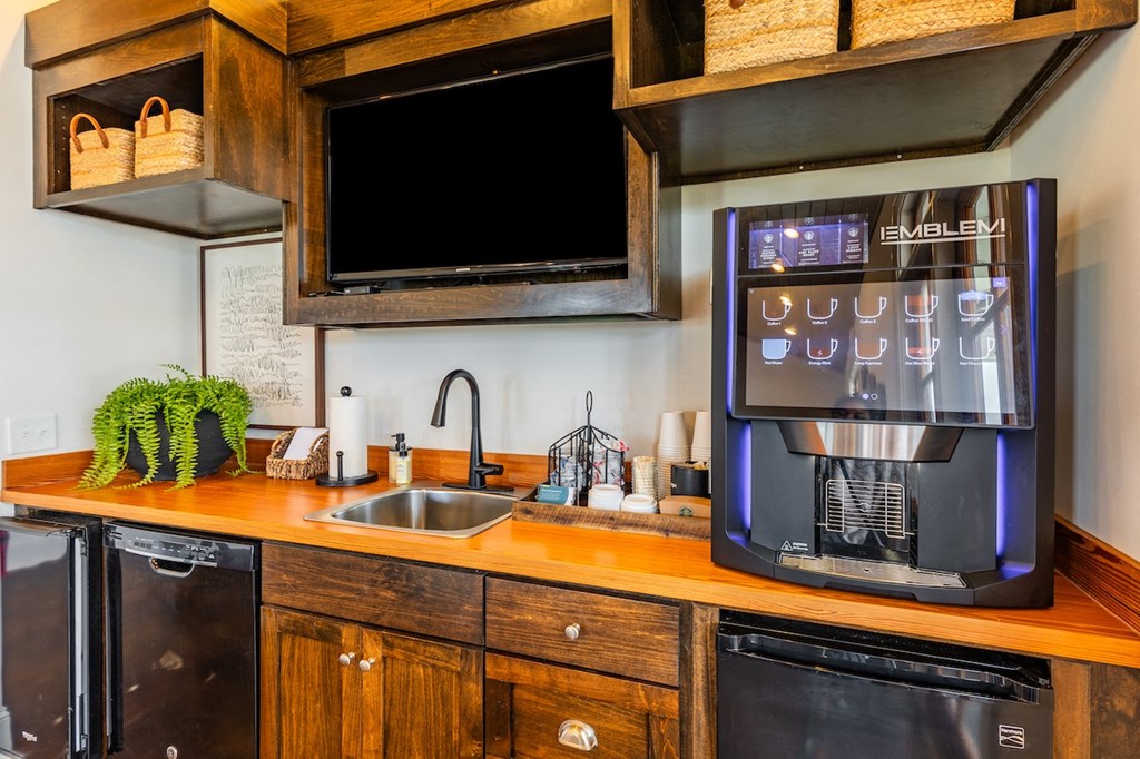 the kitchen is equipped with a coffee maker and a sink