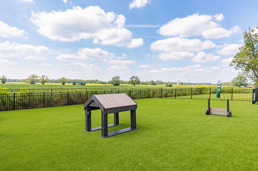 a picnic table in the middle of a lawn with a swing