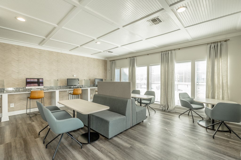 a living room with a couch and tables and chairs
