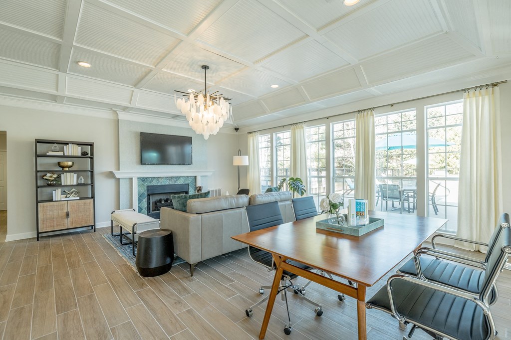 the living room has a fireplace and a large table with chairs