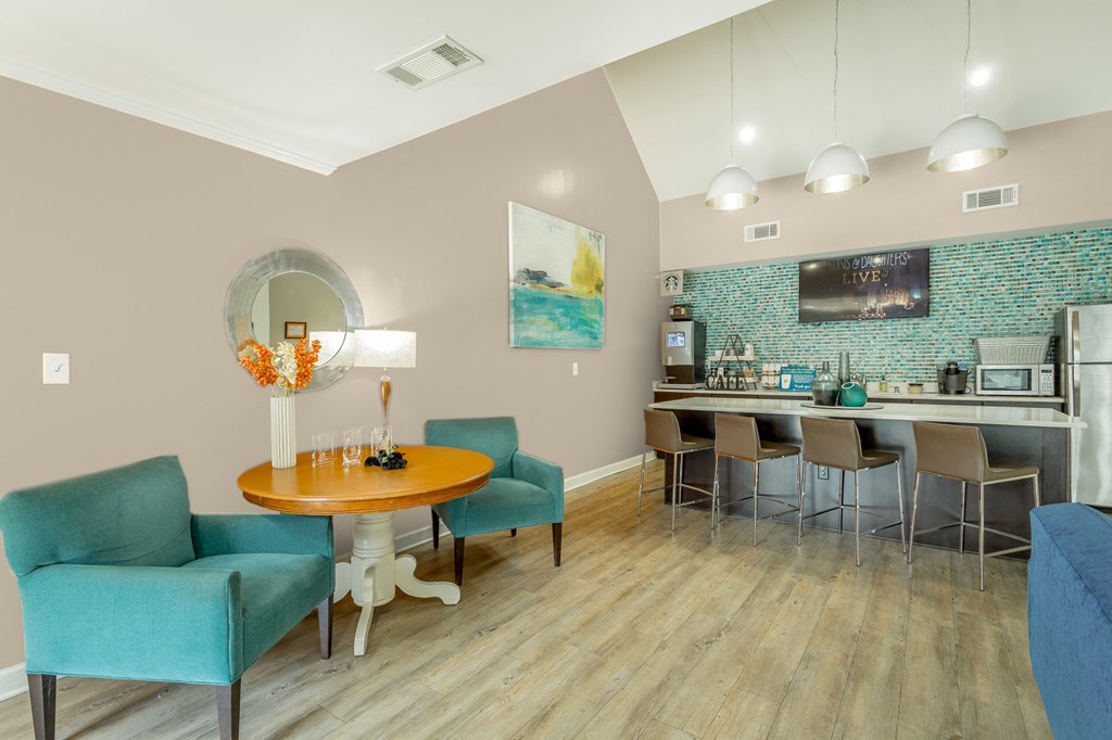 a dining room with a table and chairs and a kitchen