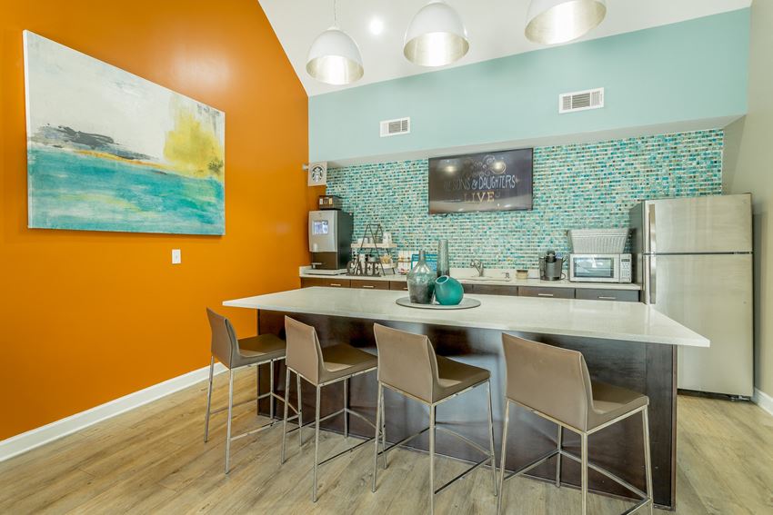 a kitchen with a large island and a counter with chairs
