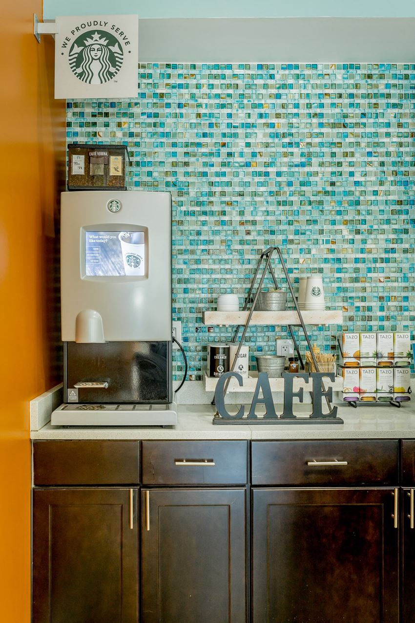 a counter with a microwave and a computer on it