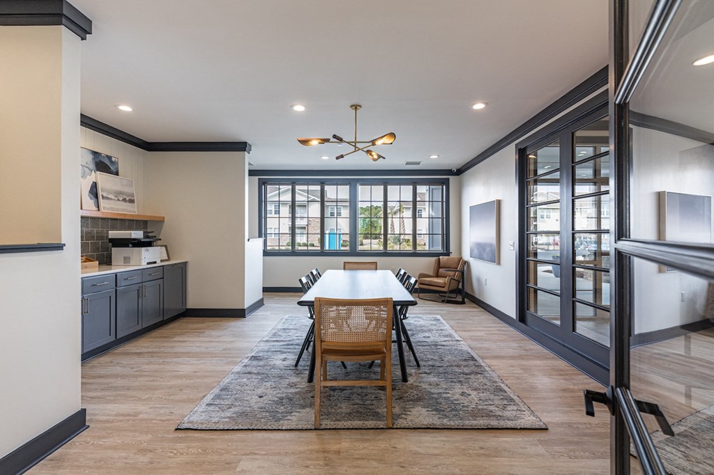 a dining room with a table and chairs and a kitchen