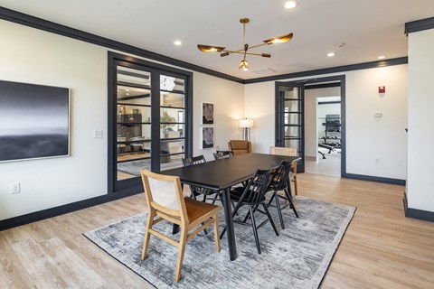 a dining room with a large table and chairs and a tv