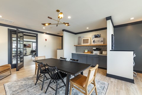 a large dining room with a table and chairs