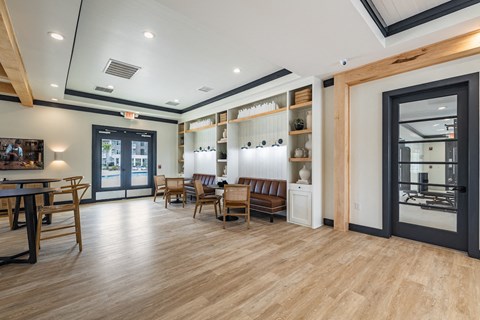 a dining room with a table and chairs and a glass door