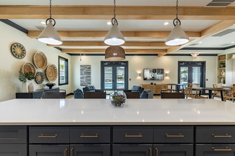 the kitchen and living room of a home with a large counter top