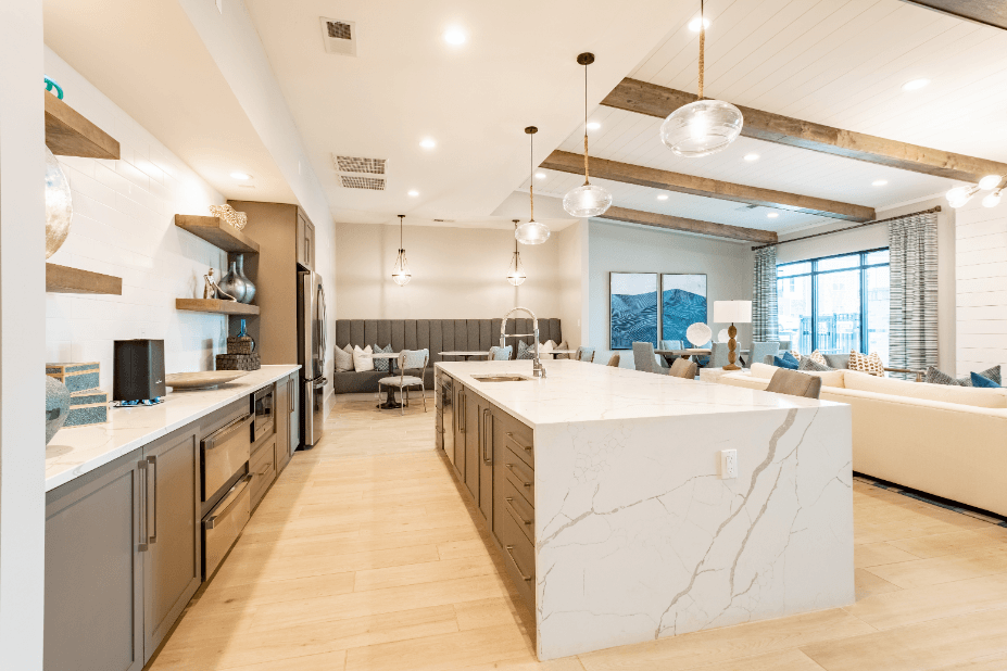 a large kitchen with a large island and a living room