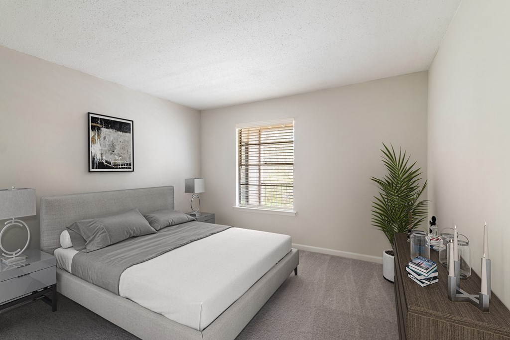 a bedroom with a bed and a dresser and a window