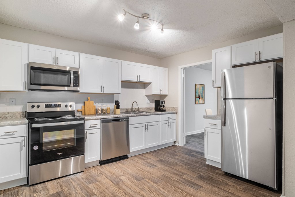 a kitchen with stainless steel appliances and white cabinets