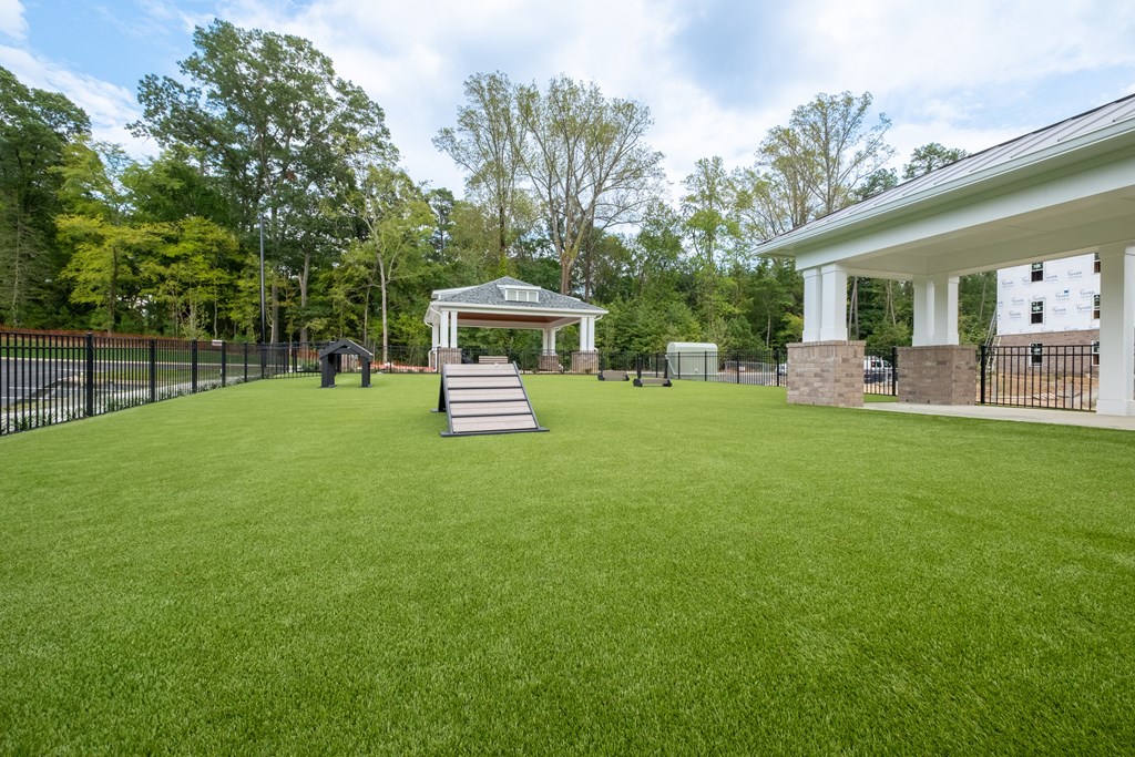 a large lawn with a gazebo on the side of a house