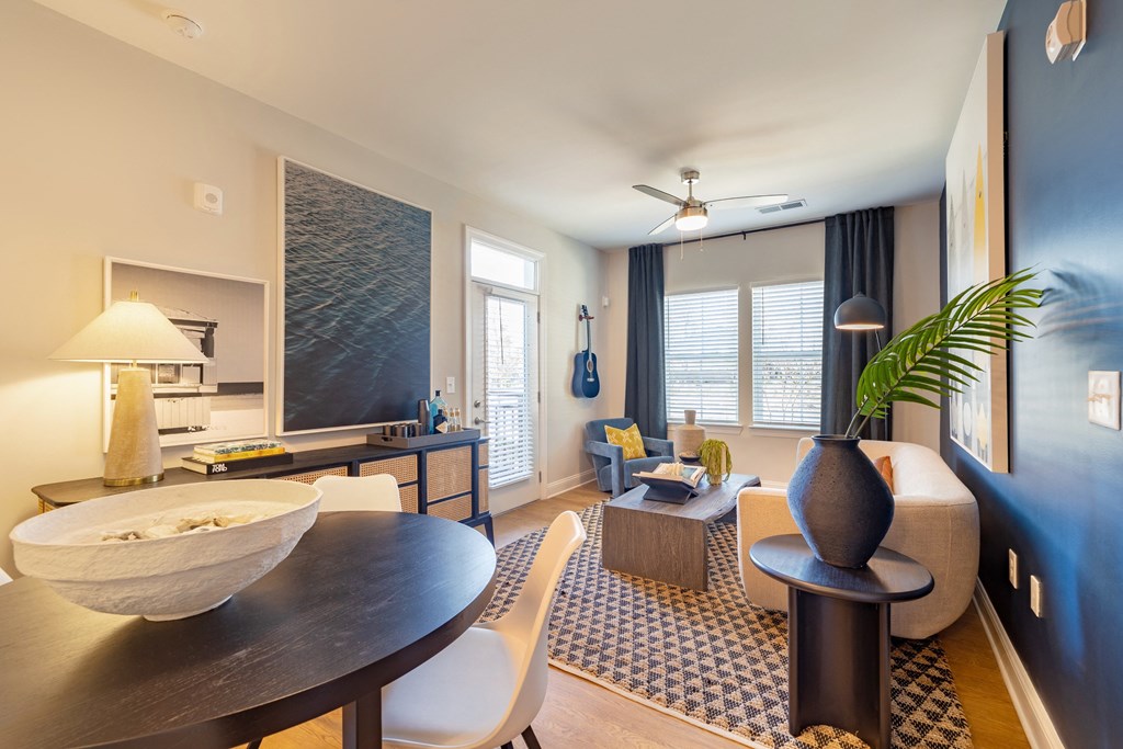 a living room with a dining room table and a couch