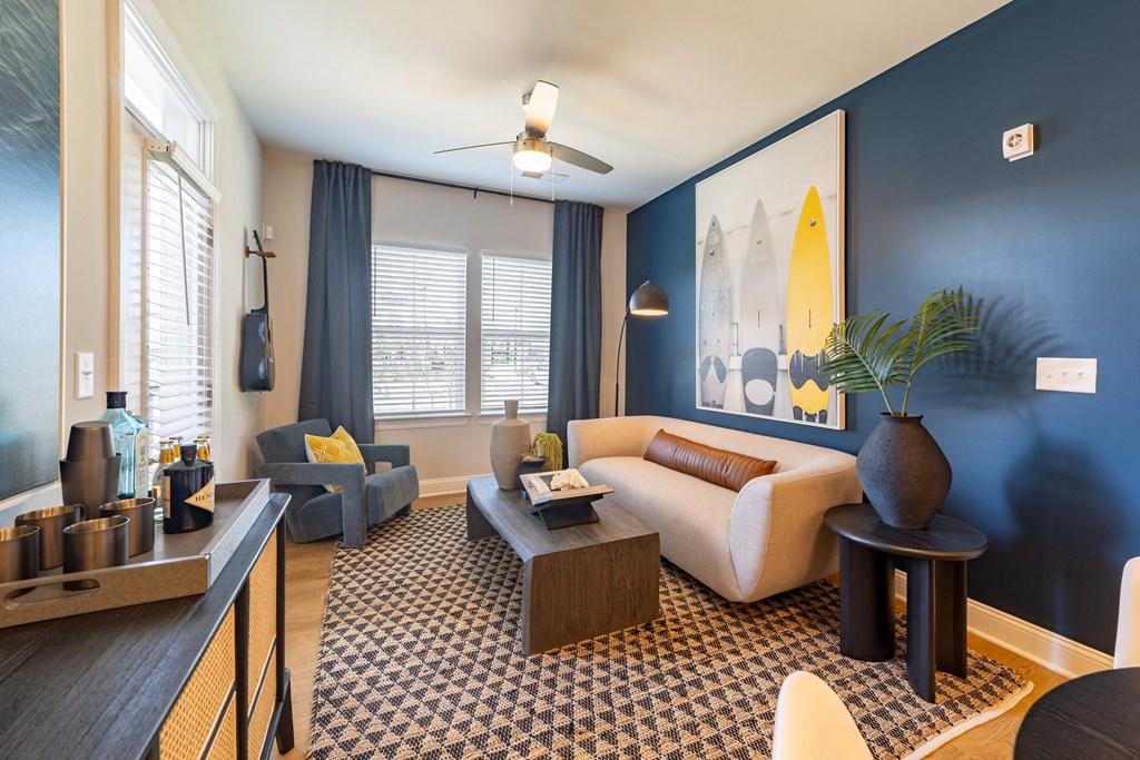 a living room with blue walls and a couch and a coffee table