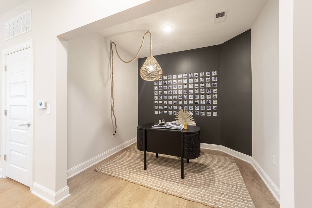 a living room with a black accent wall and a black chest of drawers