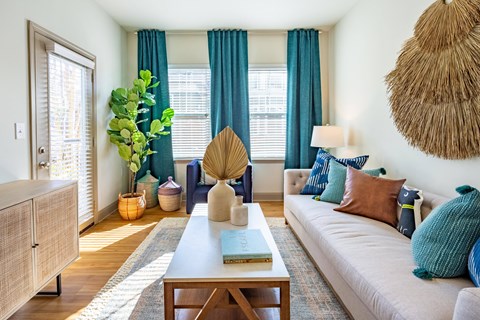 a living room with blue curtains and a white couch
